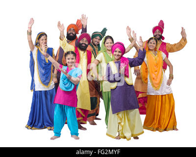 Dancers with sikh family performing folk dance bhangra MR#702X;702Y;702Z;779A;779D;779C;779B;779E;779F Stock Photo