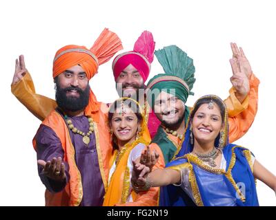 Dancers performing dancing folk dance bhangra white background MR#779B;779C;779D;779E;779F Stock Photo