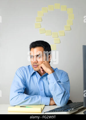 Executive thinking sticky notes on wall in background MR#779K Stock Photo