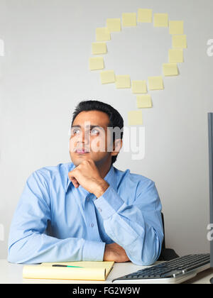Executive thinking sticky notes on wall in background MR#779K Stock Photo