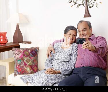 Old couple recording movement in digital camera MR#702T,702S Stock Photo