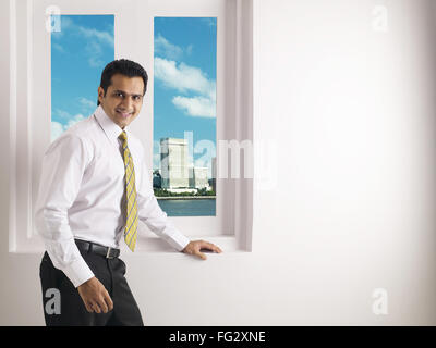 Executive standing in front of window MR#779K Stock Photo