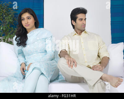 Couple sitting on sofa ; MR#779L  ; MR#779M Stock Photo