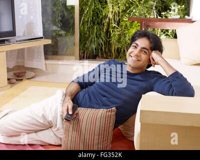 Young man sitting down looking at camera MR#702V Stock Photo