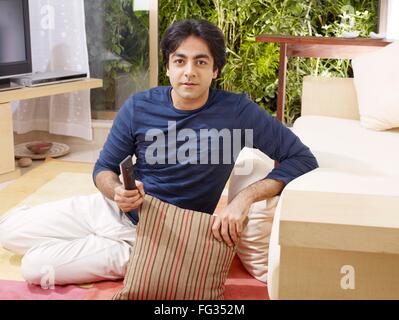 Young man sitting down looking at camera MR#702V Stock Photo