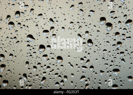 Background of water drops on a windowpane. metallic rain drops. Stock Photo