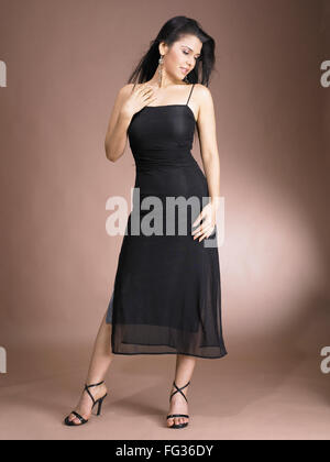 woman in black dress on brown background MR#702 Stock Photo