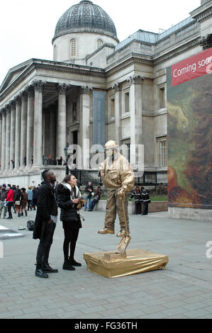 London, UK, 17 February 2016,  Attention from the authorities for living statue. The new director of the National Gallery in Trafalgar Square Dr Gabriele Finaldi calls for the removal of buskers and floating living statues from the plaza in front of the National Gallery and replacement with more approapriate art forms. Credit:  JOHNNY ARMSTEAD/Alamy Live News Stock Photo