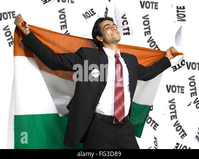 Executive holding national flag of India on his backside with vote stripes in background MR#702A Stock Photo