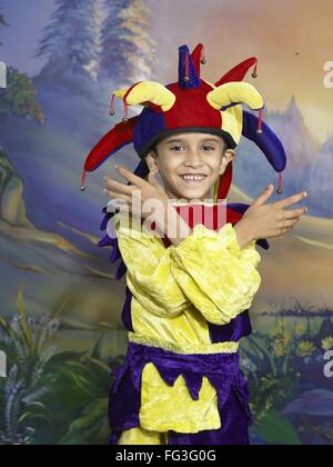 South Asian Indian boy dressed as joker performing fancy dress competition on stage in nursery school MR Stock Photo