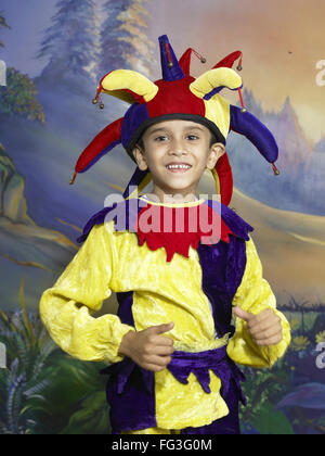 South Asian Indian boy dressed as joker performing fancy dress competition on stage in nursery school MR Stock Photo