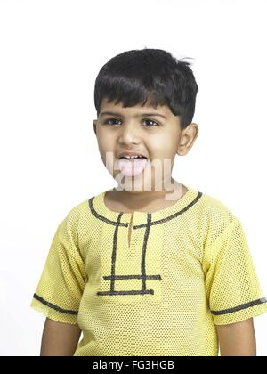 South Asian Indian boy making funny face in nursery school MR Stock Photo