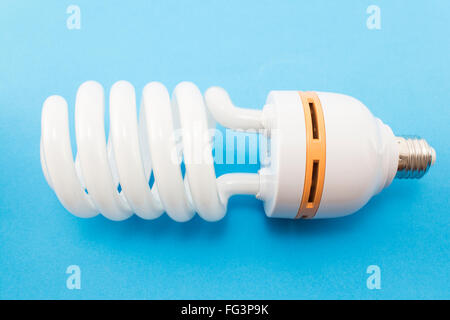 Energy saving light bulb on a blue background. Stock Photo