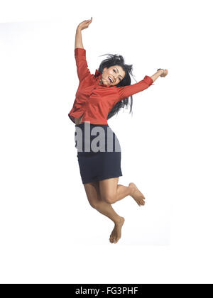 South Asian Indian executive woman jumping with joy MR Stock Photo