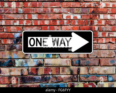 One Way Sign on Brick Wall Stock Photo