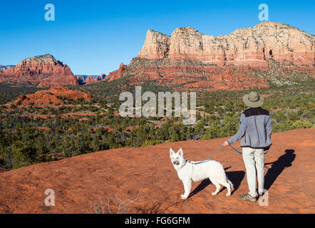 Hiker and dog at overlook reached via the Bell Rock Climb trail Stock Photo