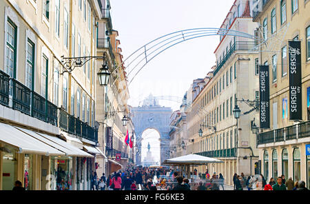 People on Augusta street with the Triumphal Arch, the famous tourist attraction in Lisbon. Stock Photo