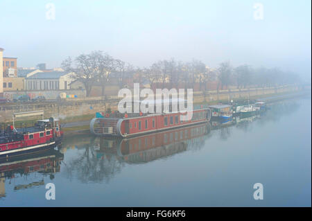 Boats on the Wistula river in the foggy morning. Krakow, Poland Stock Photo