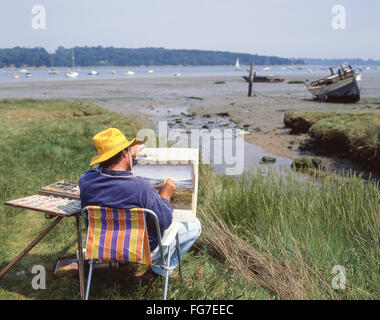 Male artist painting landscape near Aldeburgh, Suffolk, England, United Kingdom Stock Photo