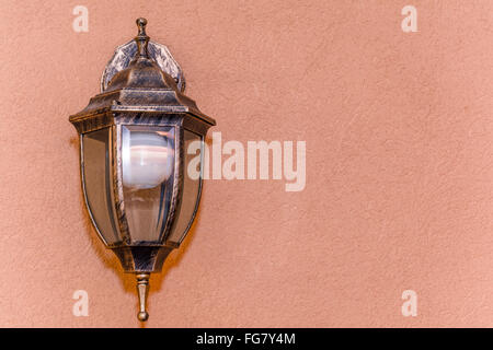 Old beautiful lantern an orange nice wall Stock Photo