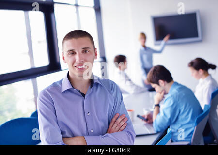 business man  on a meeting in offce with colleagues in background Stock Photo