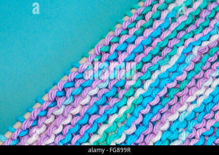 Homemade knitted dishcloth made with cotton yarn. Stock Photo