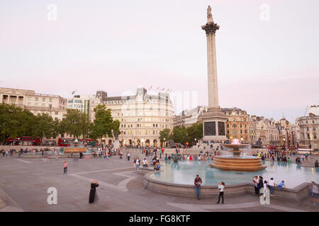 Trafalgar square with people and tourists at dusk in London Stock Photo