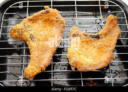 Two Crispy Cooked Pork Chops Hot From the Oven Stock Photo