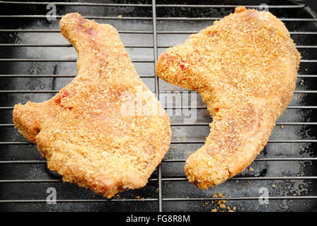 Two Raw Breaded Pork Chops Ready for the Oven Stock Photo