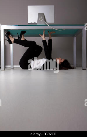 woman lying on the floor in the office Stock Photo