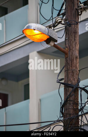 Closeup of illuminated street bulb and many electrical cables Stock Photo