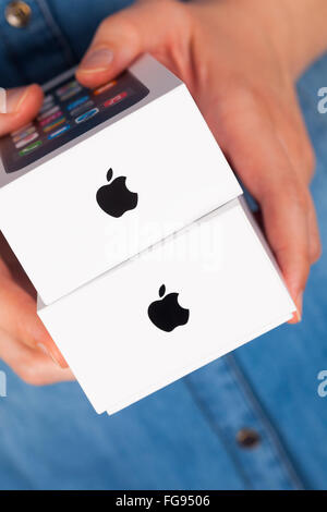 Tambov, Russian Federation - January 12, 2015: Two Apple iPhone white boxes in womans hands. Studio shot. Stock Photo