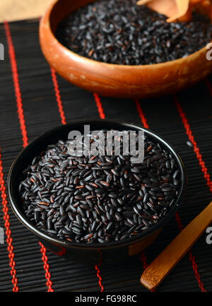 Dry Organic Black Forbidden Rice in a Bowl Stock Photo - Alamy