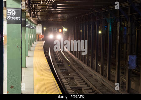 The number 1 subway approaching the 59th Street/Columbus Circle station - Manhattan, NY Stock Photo