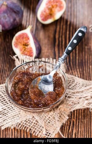 Homemade Fig Jam (detailed close-up shot) with fresh fruits on wooden background Stock Photo