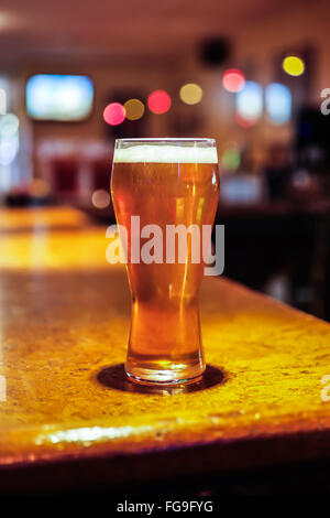 Beer glass on a restaurant bar counter Stock Photo