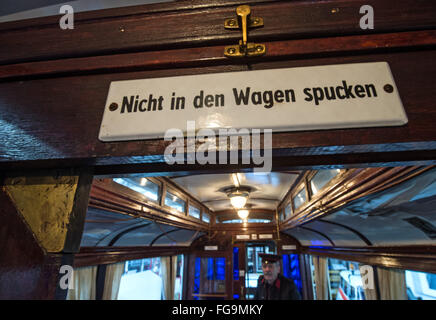 A sign reading 'Nicht in den Wagen spucken' (lit. 'Do not spit in the car') in the Merseburg overland railway from 1912 the tram museum in Halle, Germany, 18 February 2016. Halle is known as a pioneering city in the tram history with the first electrical tram network in Europe, having been erected in 1891. In the central station, the exhibition '125 Jahre elektrisiert durch Halle (Saale)' (lit. '125 years electrified through Halle') is opening tonight. PHOTO: HENDRICK SCHMIDT/dpa Stock Photo