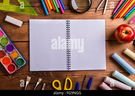 Desk, school supplies, lined paper, wooden background, copy spac Stock Photo