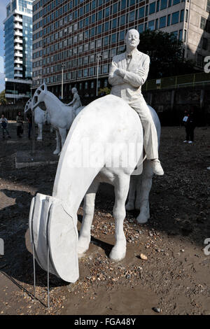 'The Rising Tide'  sculptures by Jason deCaires Taylor, installed on the foreshore of the River Thames, Nine Elms, London, UK. Stock Photo