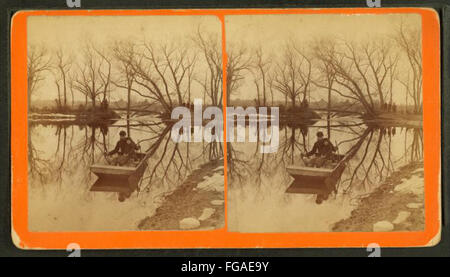 A main and child in flat bottomed boat, by Simpson Stock Photo