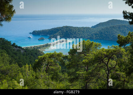 A aerial view through the pine trees of Olu Deniz and the blue lagoon, Fethiye, Turkey. Stock Photo