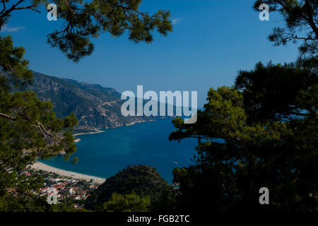 A aerial view through the pine trees of Olu Deniz and the blue lagoon, Fethiye, Turkey. Stock Photo