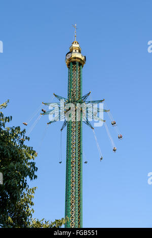 People Having Fun In Carousel Swing Ride At Amusement Park Stock Photo