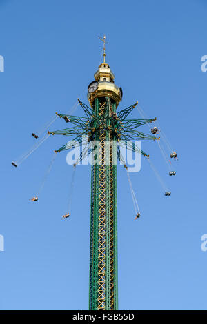 People Having Fun In Carousel Swing Ride At Amusement Park Stock Photo