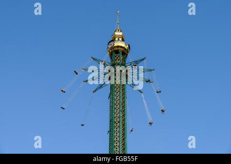 People Having Fun In Carousel Swing Ride At Amusement Park Stock Photo