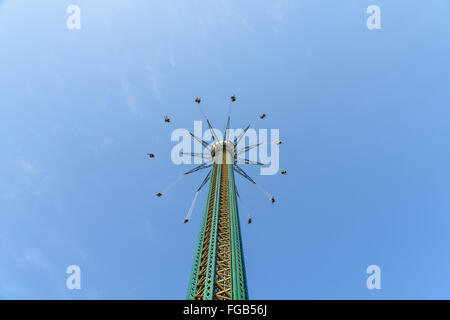 People Having Fun In Carousel Swing Ride At Amusement Park Stock Photo