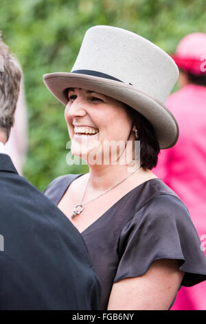 top hat,Exchange of hats.Woman wearing top hat at Royal Ascot horse race meeting,Ascot,Berkshire,England,U.K. Europe. Stock Photo