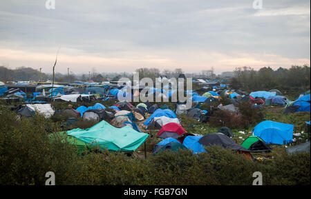 An overview of a large section of the Jungle Refugee and Migrant Camp in Calais. Tents and temporary shelters into the distance. Stock Photo
