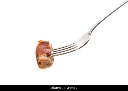 Piece of sausage on a fork isolated against white Stock Photo