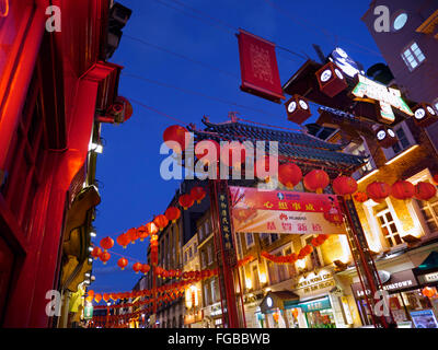 Chinese entrance gate to Gerrard Street at night with traditional Chinese lanterns Chinatown Soho London W1 Stock Photo